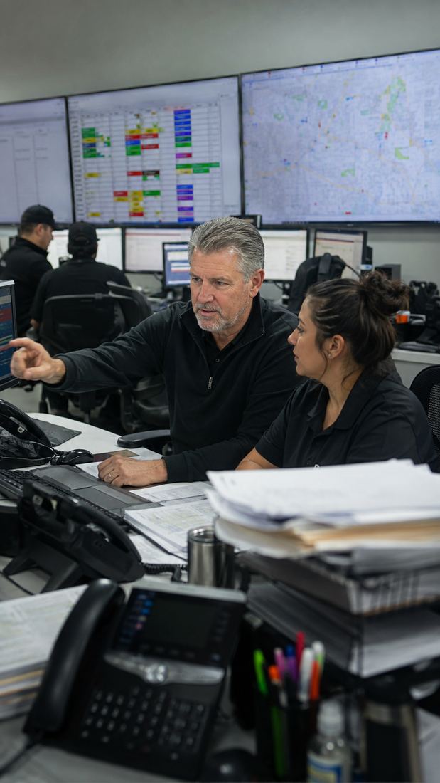 An inside sales and order desk team buried in phones and paperwork